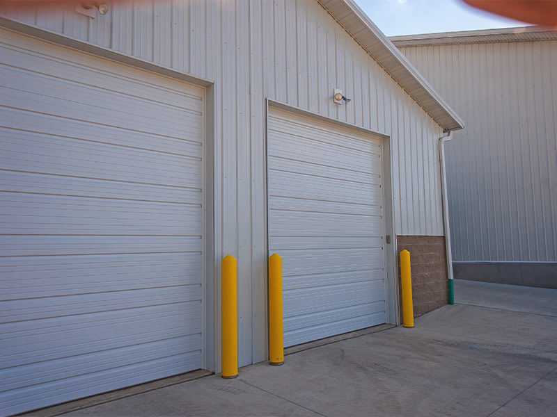 Commercial property with insulated and ribbed custom steel garage doors.
